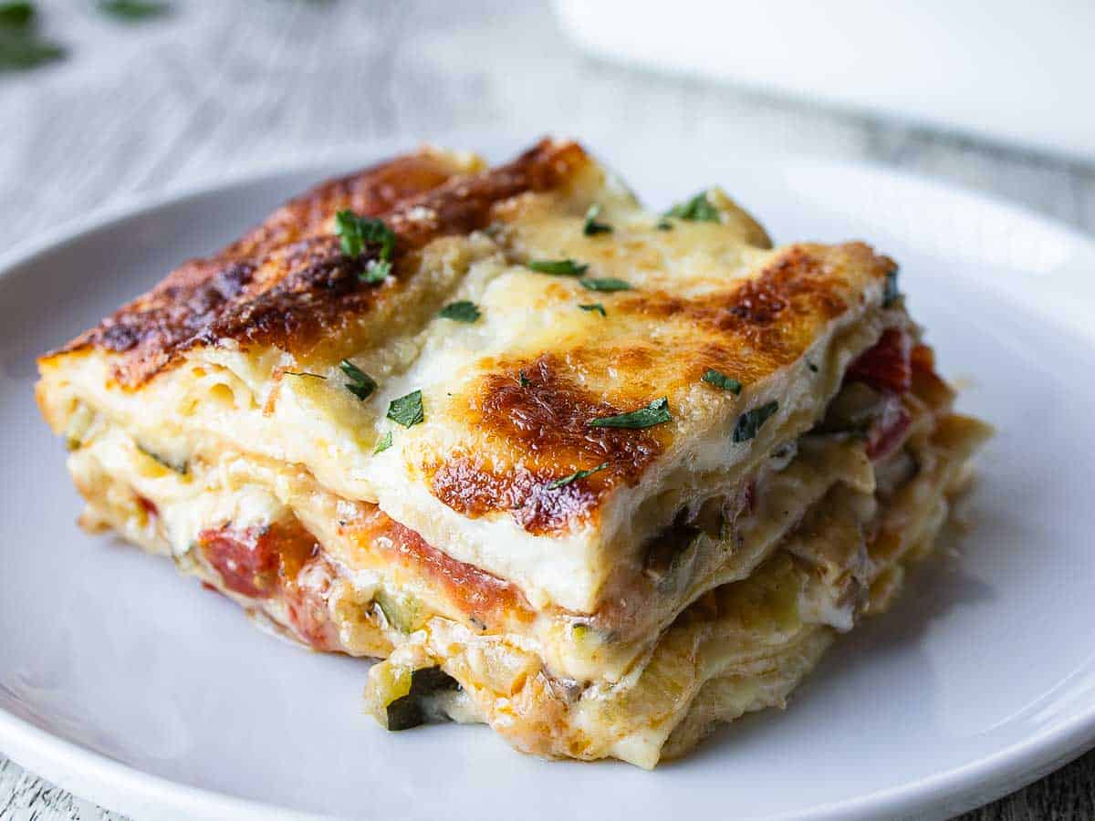 Piece of veggie lasagna on a plate.