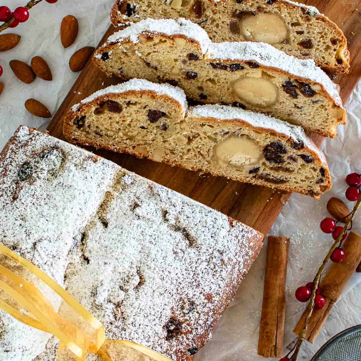 Stollen Bread viewed from above with three slices cut.