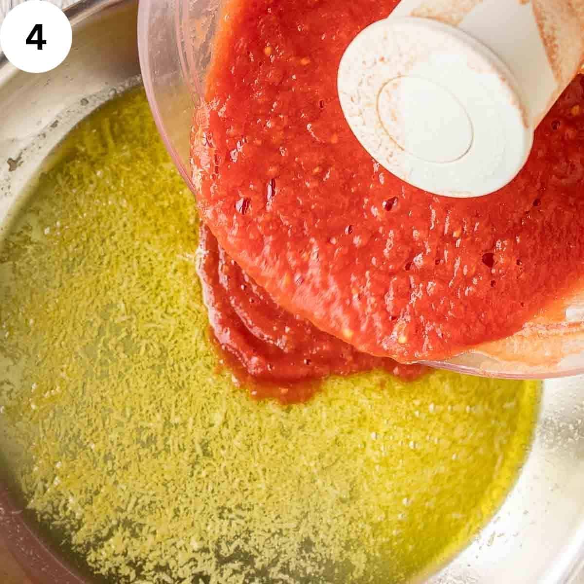 Pouring tomato puree into olive oil and garlic.