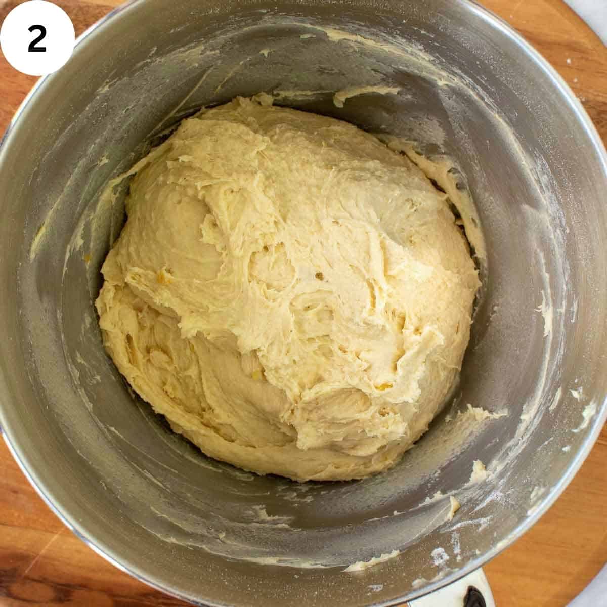 Sticky dough in a stainless steel mixing bowl.