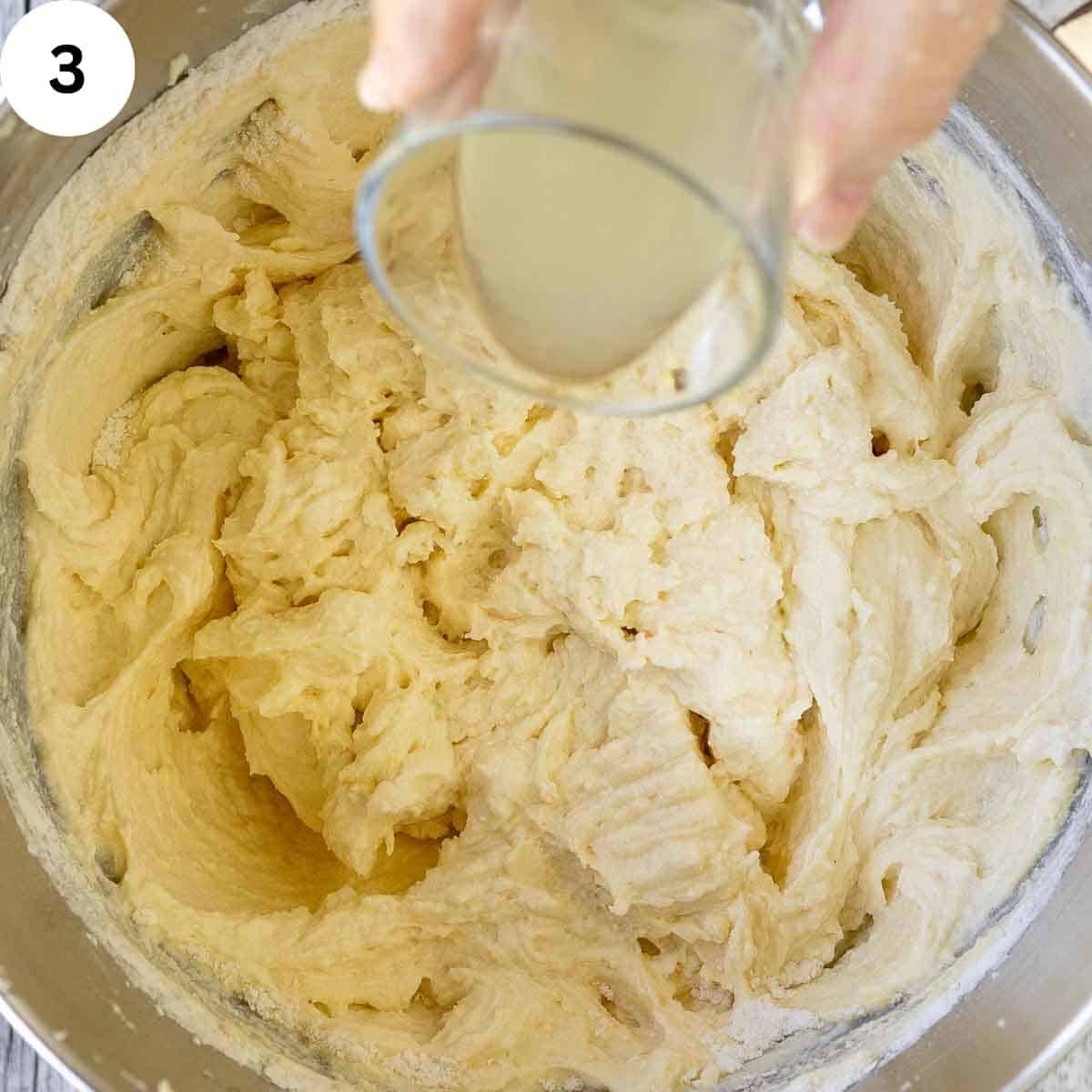 Lemon juice being poured into a cake batter.