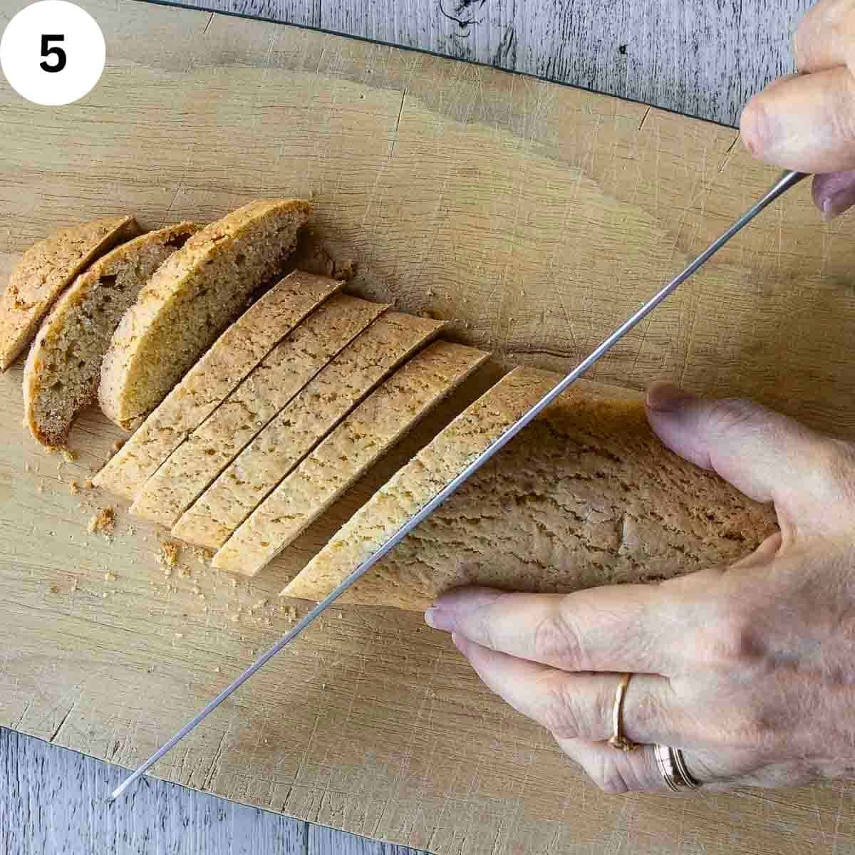Cutting a baked loaf into biscotti.