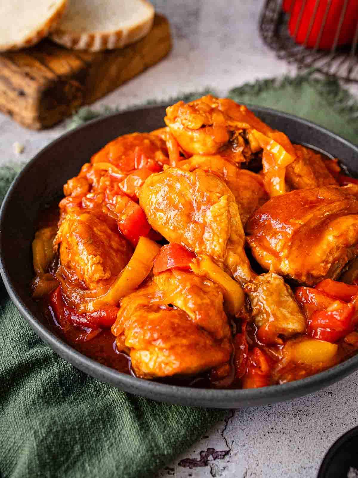 This is a chicken and peppers recipe prepared and served in a shallow bowl.