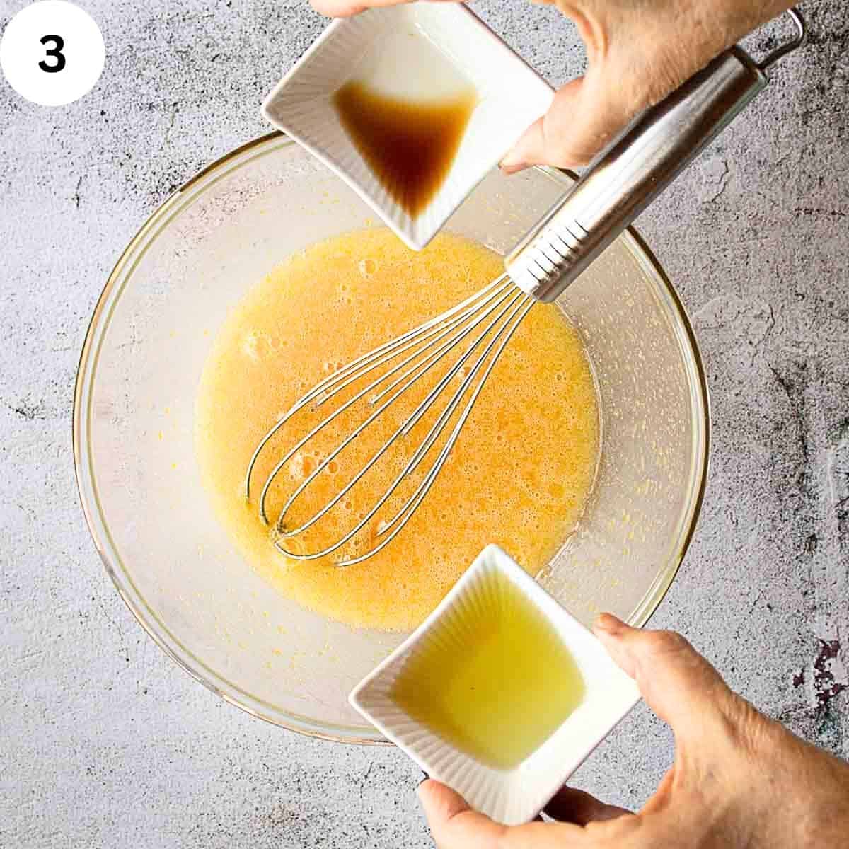 Adding anise extract and vanilla extract to beat eggs in a bowl.