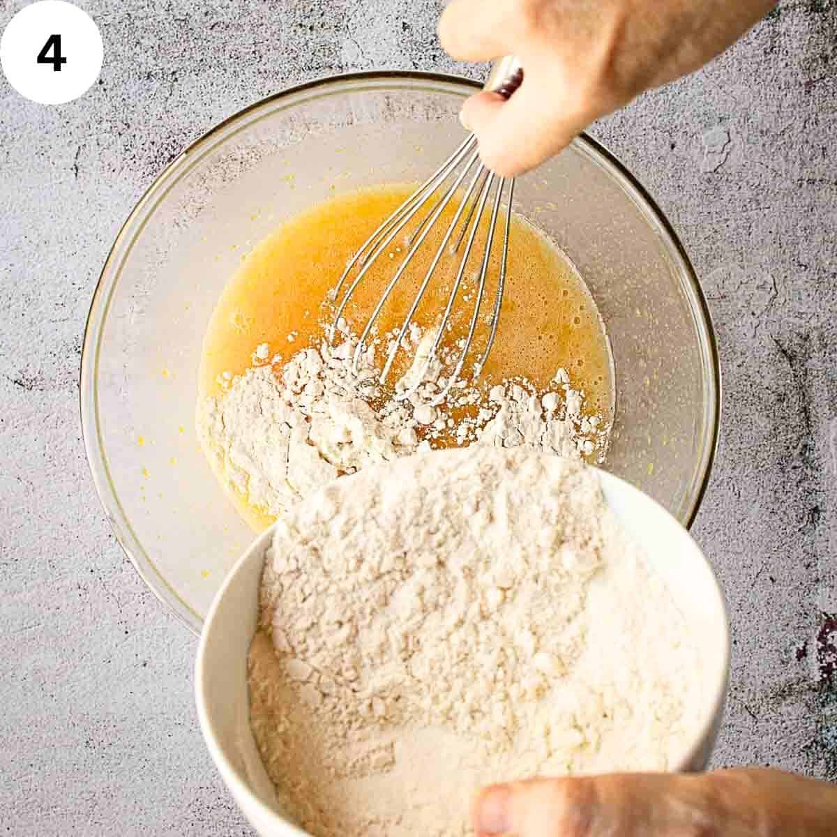 Adding flour to beaten eggs in a bowl.