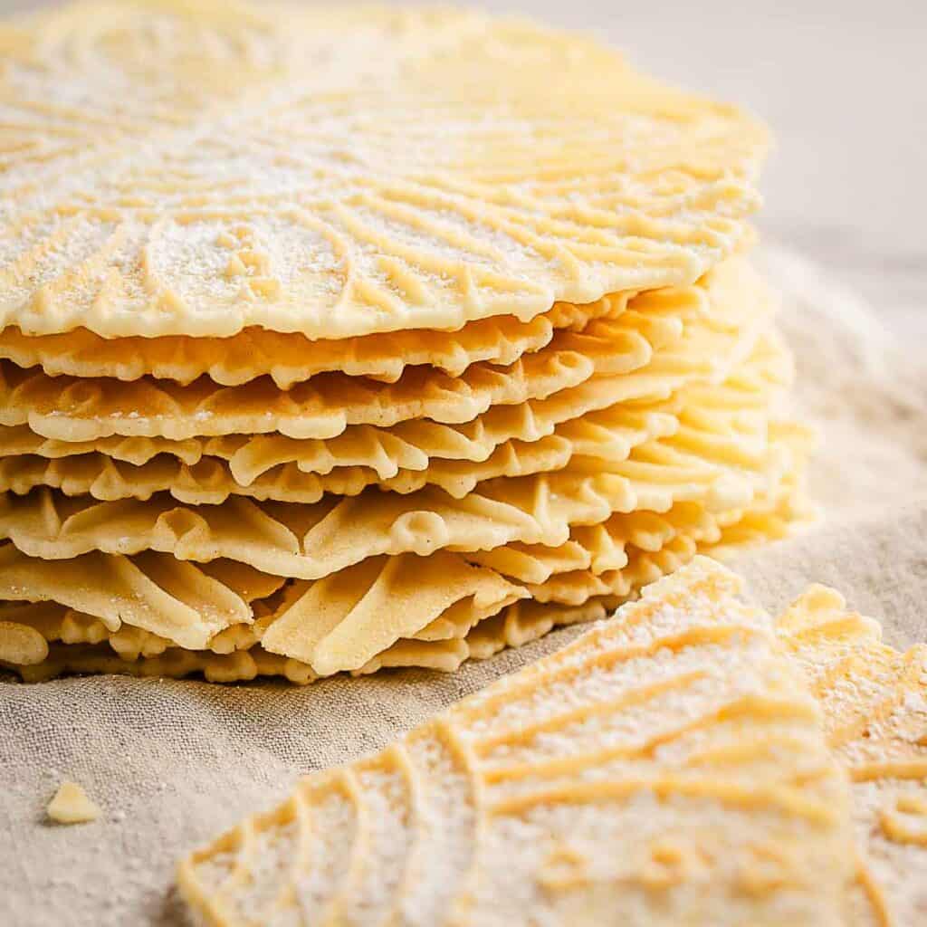 A stack of pizzelle cookies made from an anise pizzelle recipe.