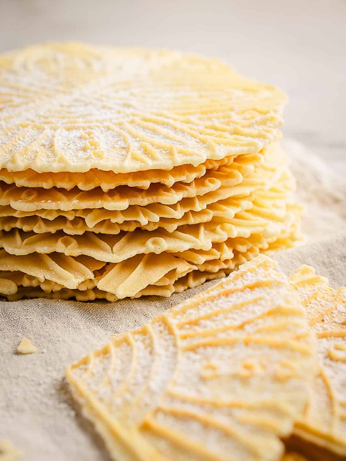 A stack of pizzelle cookies made from an anise pizzelle recipe.