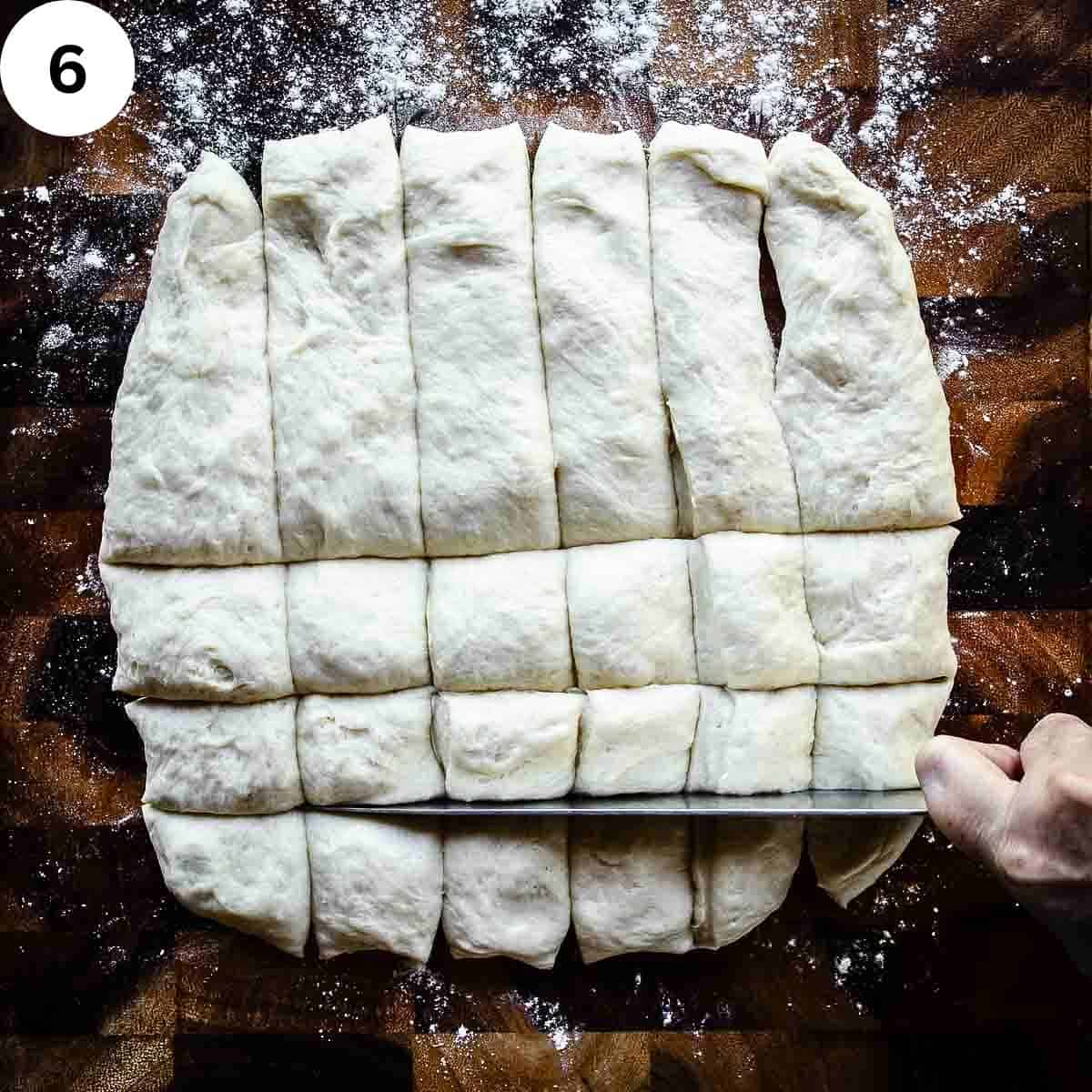 Cutting a square of dough into pieces.
