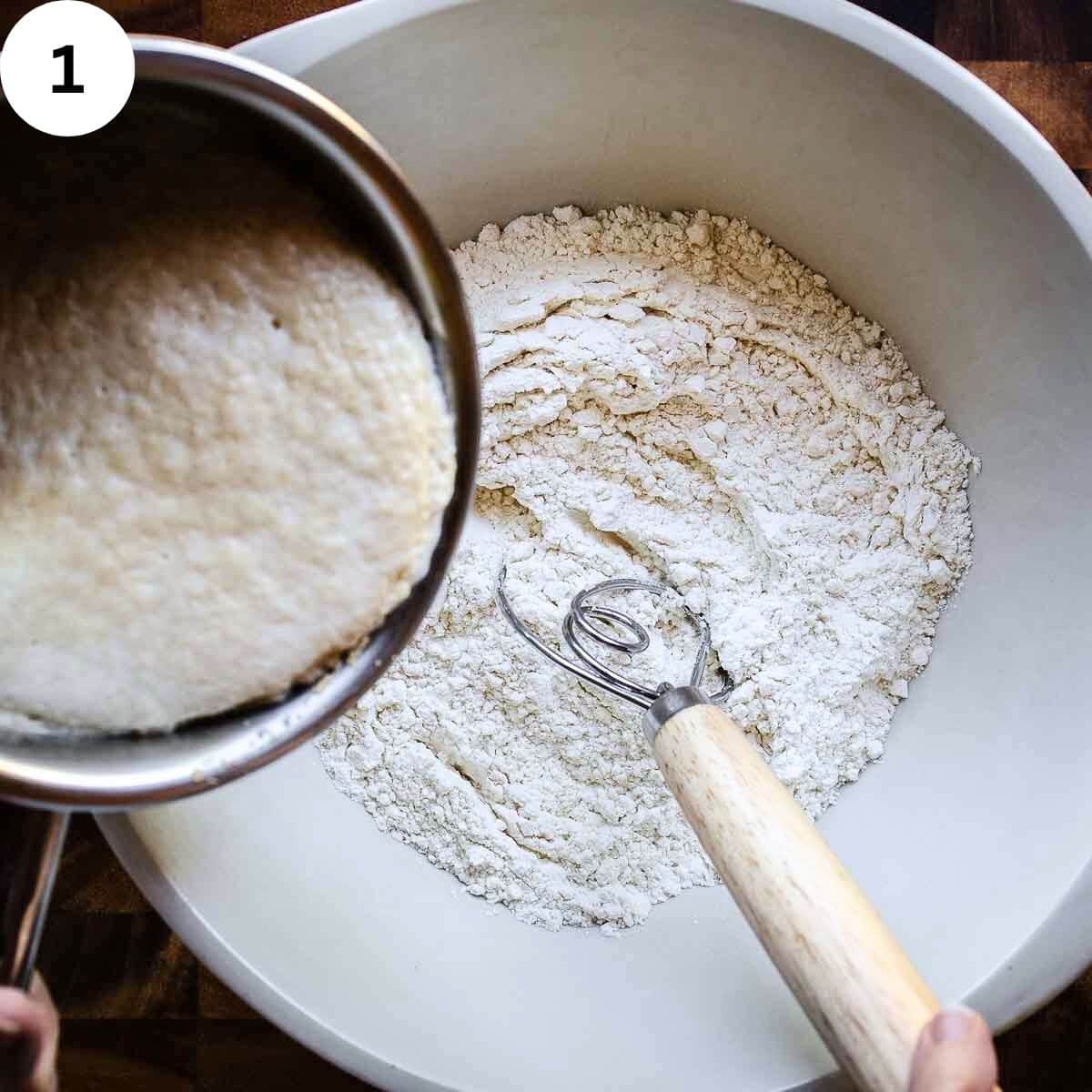Adding proof yeast and milk to flour.