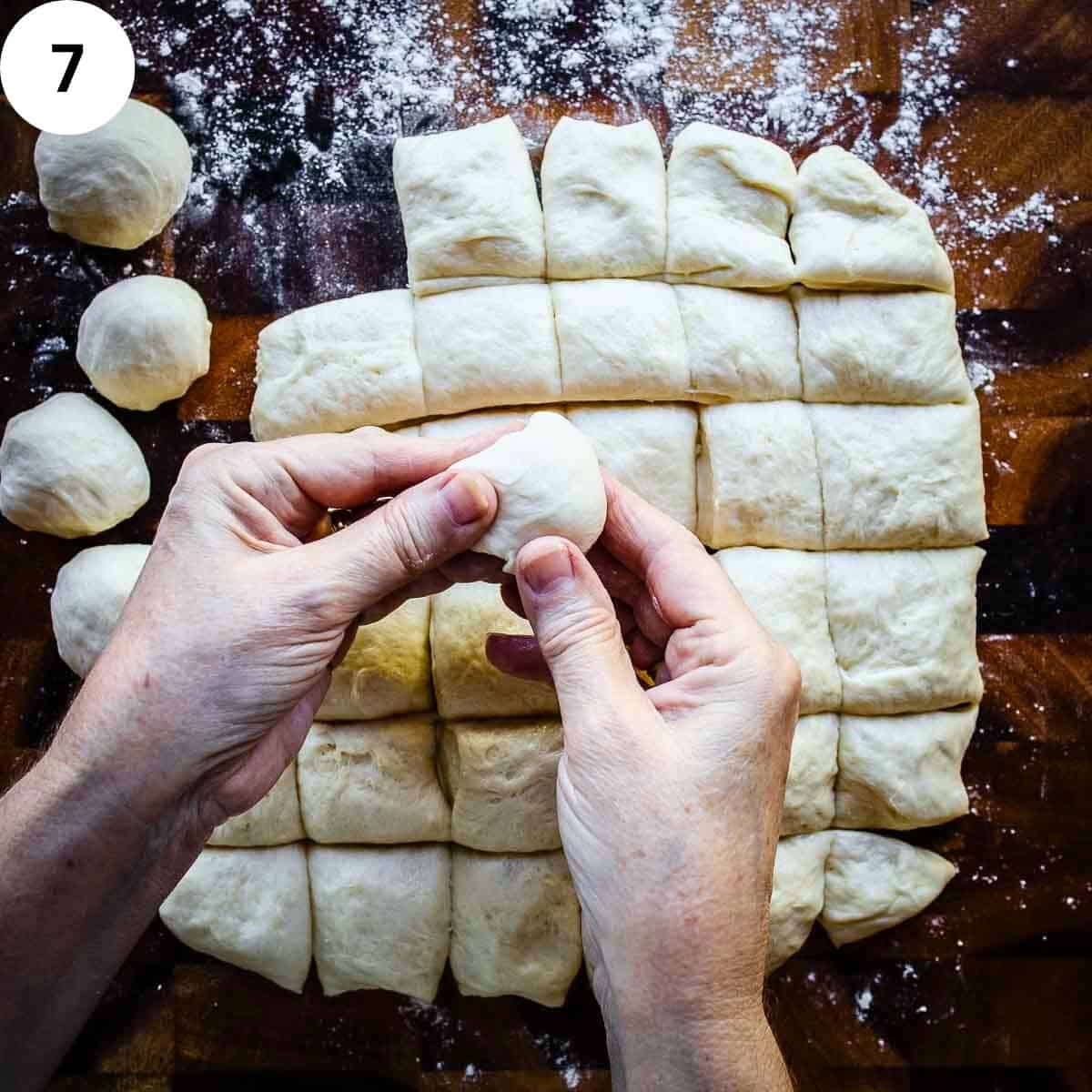 Shaping small pieces of bread dough into balls.