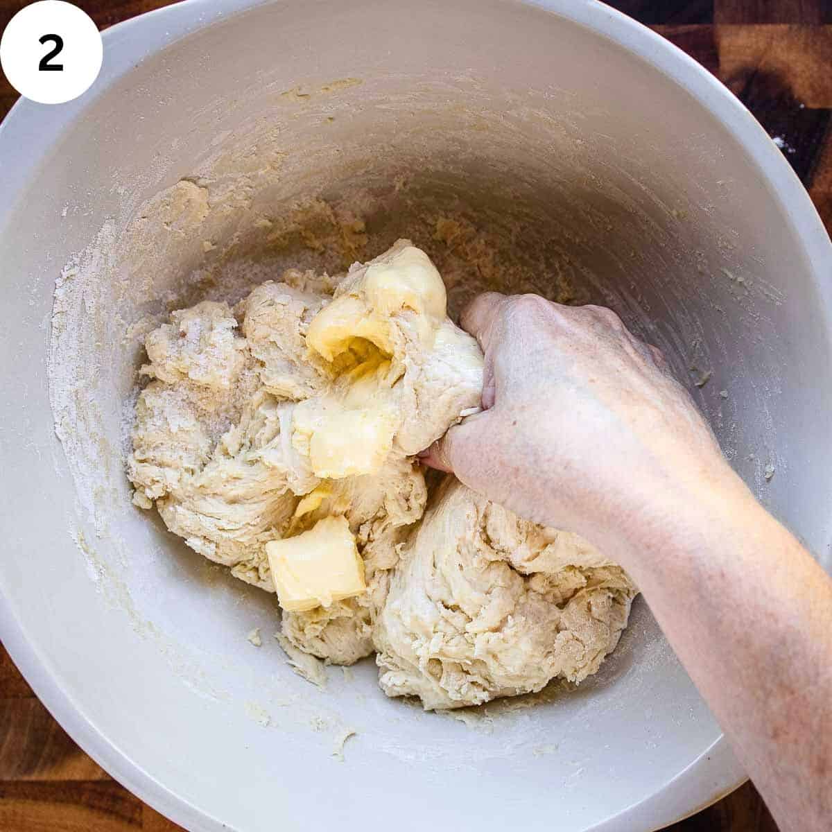 Squishing butter into dough.
