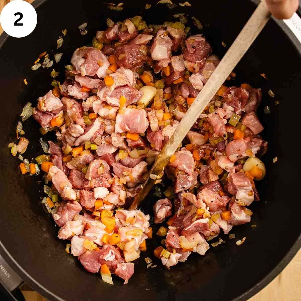 Cooking diced pork shoulder for ragu.