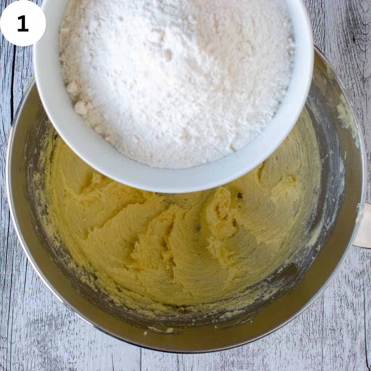 Pouring flour into beaten butter and sugar mixture.
