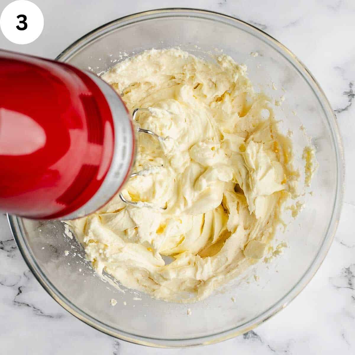 Combining mascarpone into whipped ricotta.