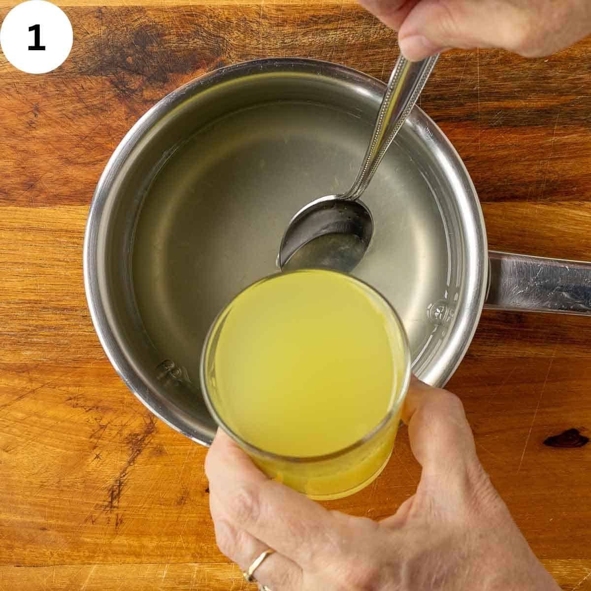 Pouring limoncello into sugar syrup.