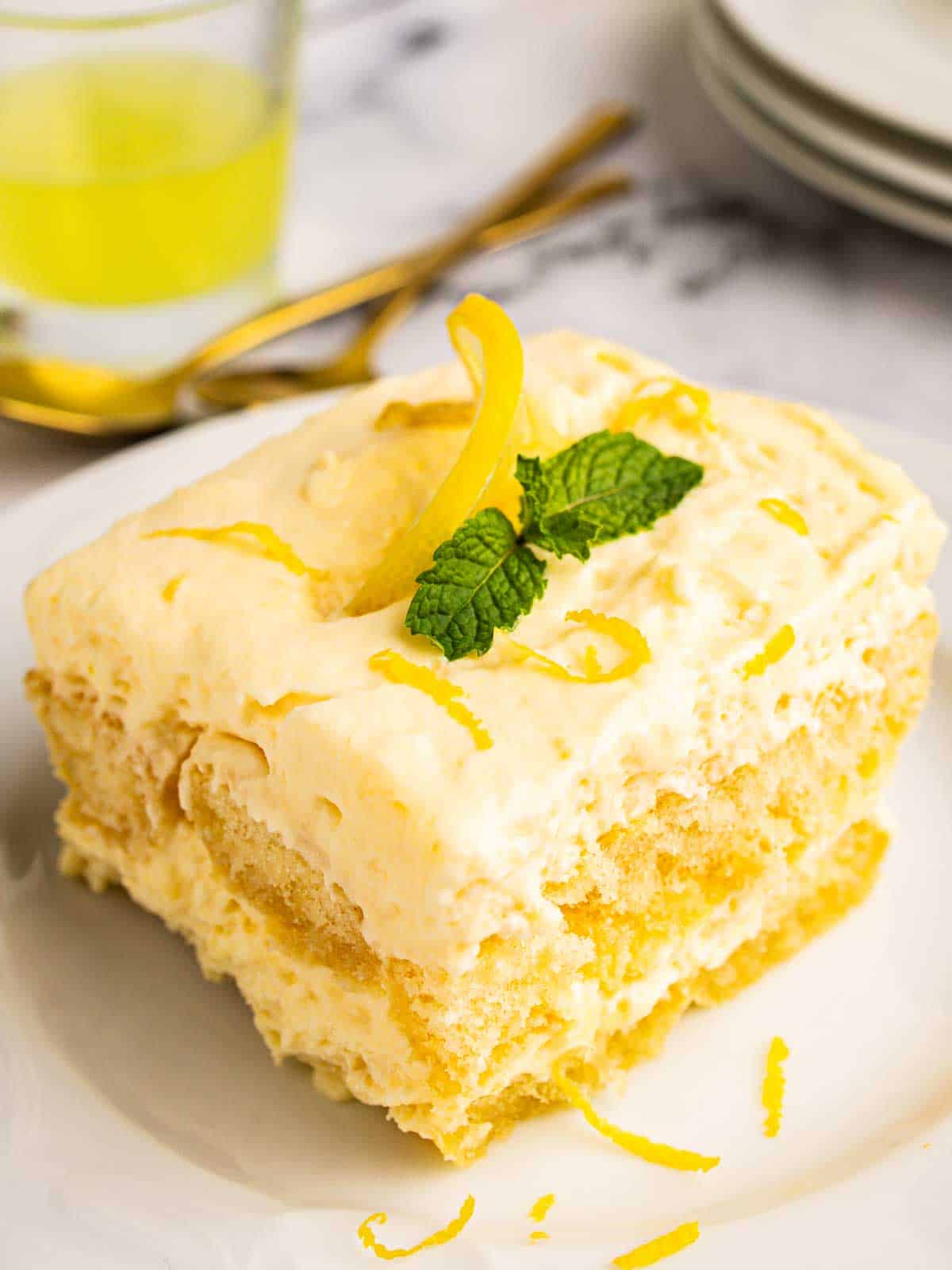 Serving of creamy dessert showing layers of soaked ladyfingers and creamy filling.