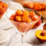 Peach compote in a martini glass.